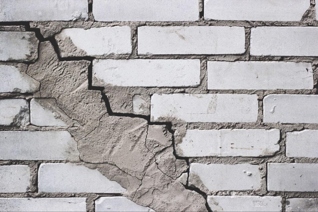 Cracked white brick wall texture perfect for backgrounds and design projects.
