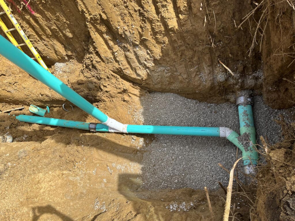 Municipal sewer repair showcasing modern trenching and pipe replacement.