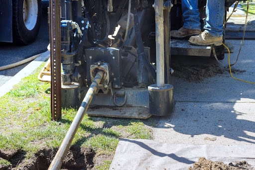 Drilling machine in operation for trenching and underground installation work.