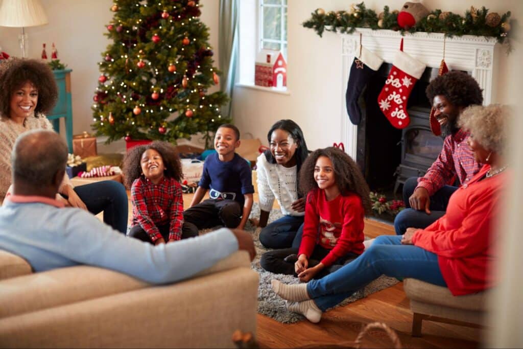 Joyful family gathering by the Christmas tree, celebrating togetherness and holiday cheer.